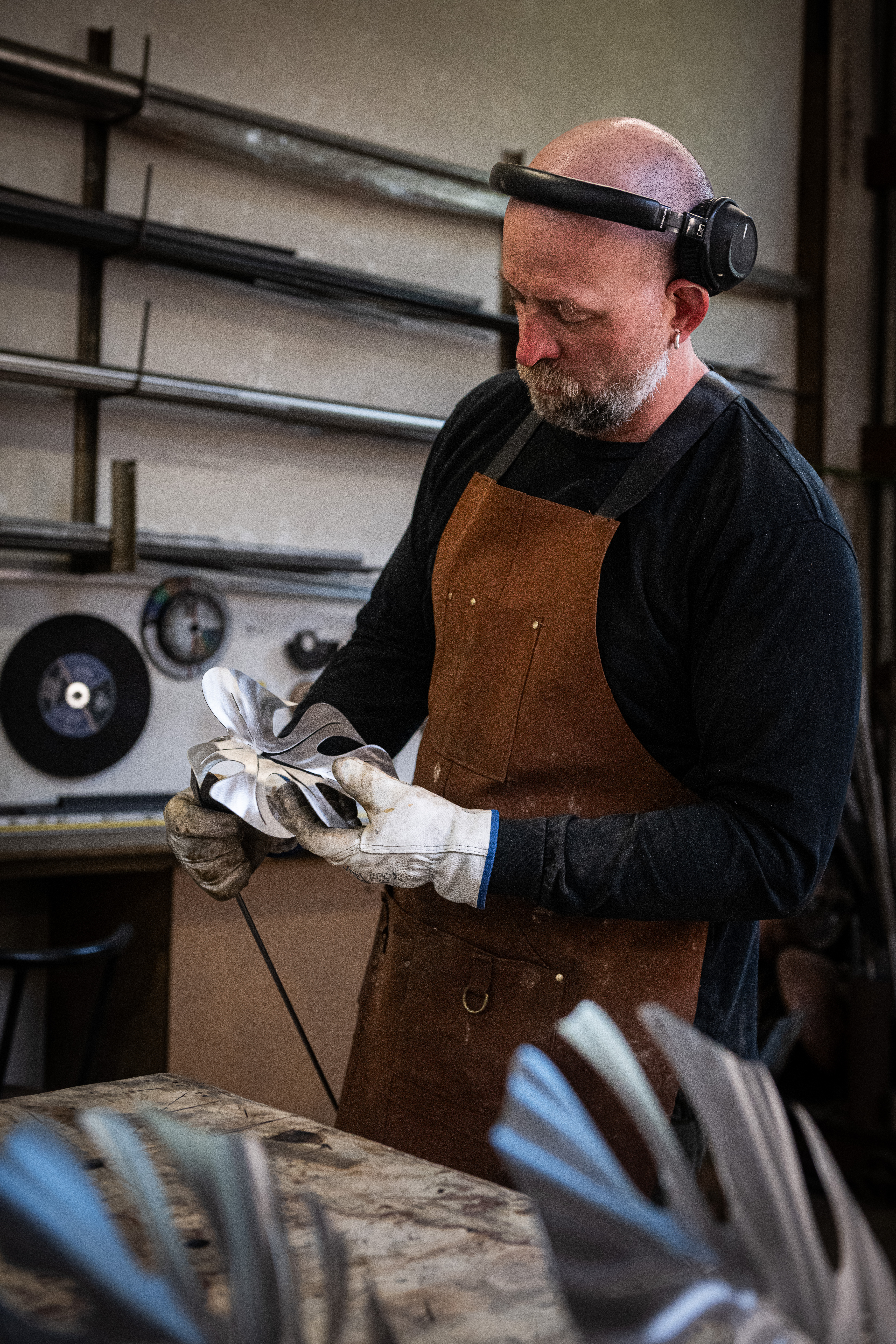 Artist heating a monstera leaf with a torch